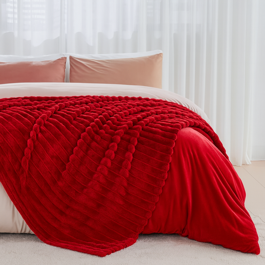 Warm fleece throw blanket draped across bed — lightweight and all-season comfort